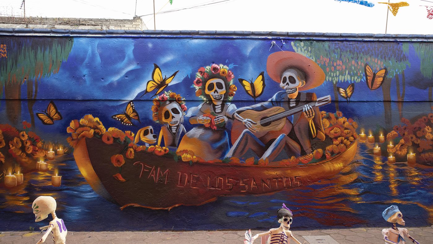 Mural de calaveras en trajinera con cempasúchil y velas, CDMX